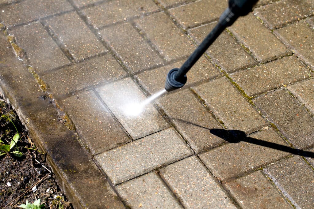 High pressure washer cleans with jet of water the concrete floor | Shineo | Office Cleaning Sydney